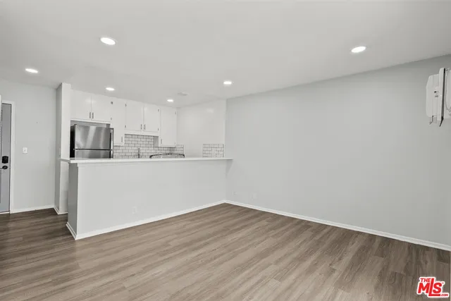 a view of kitchen with wooden floor and window
