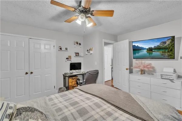 a bedroom with a bed and a flat screen tv