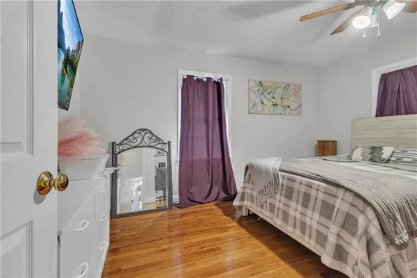 a bedroom with a bed and a painting on the wall