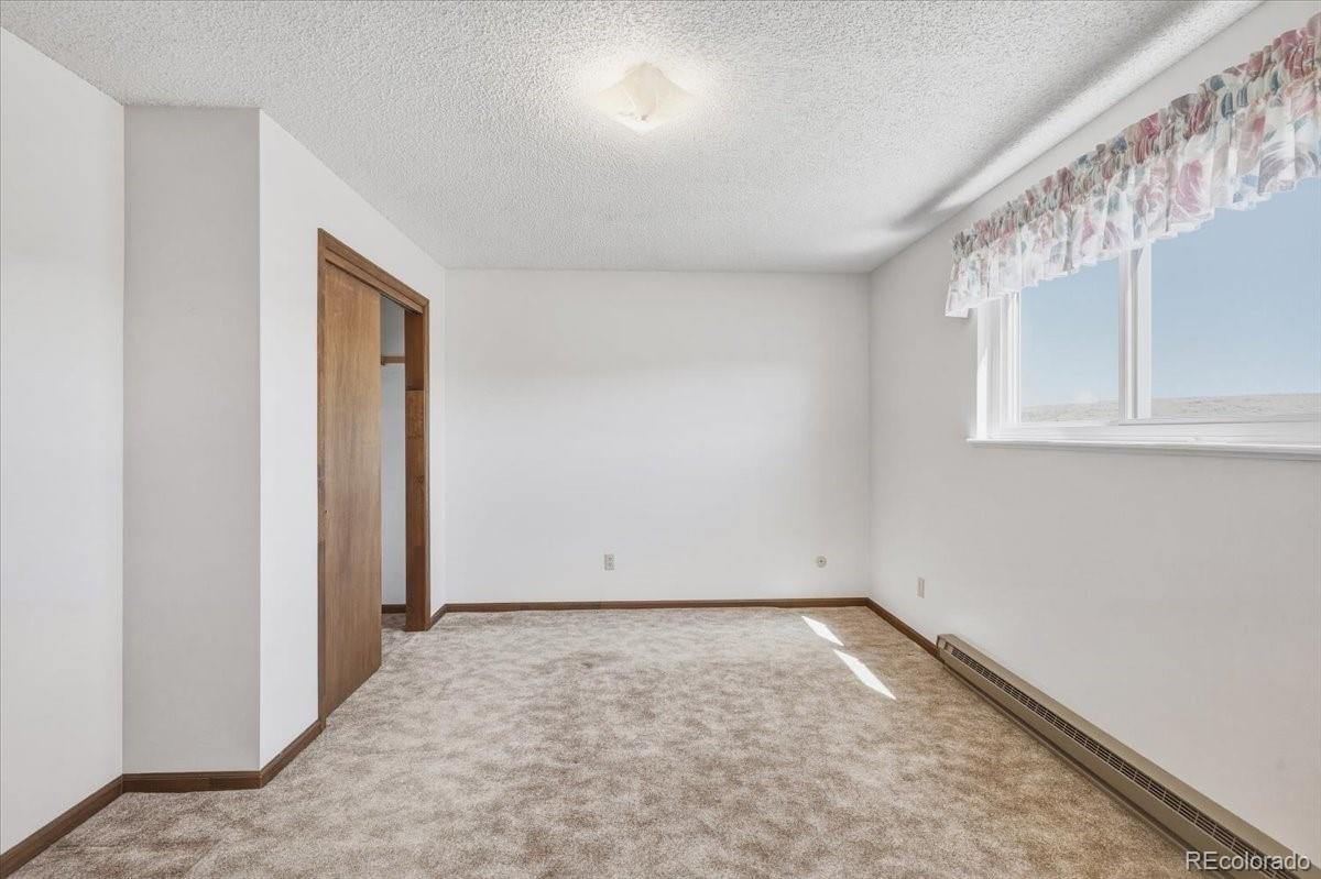 12720 South Mesa View Road Larkspur, CO 80118 - Photo 19 of 45 an empty room with windows