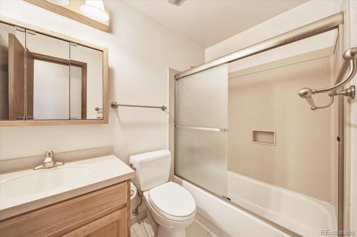 12720 South Mesa View Road Larkspur, CO 80118 - Photo 23 of 45 a white toilet sitting next to a bathroom sink