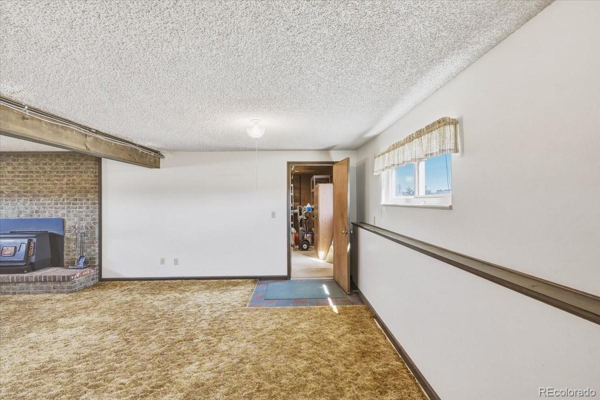 12720 South Mesa View Road Larkspur, CO 80118 - Photo 30 of 45 a view of an empty room with window and wooden floor