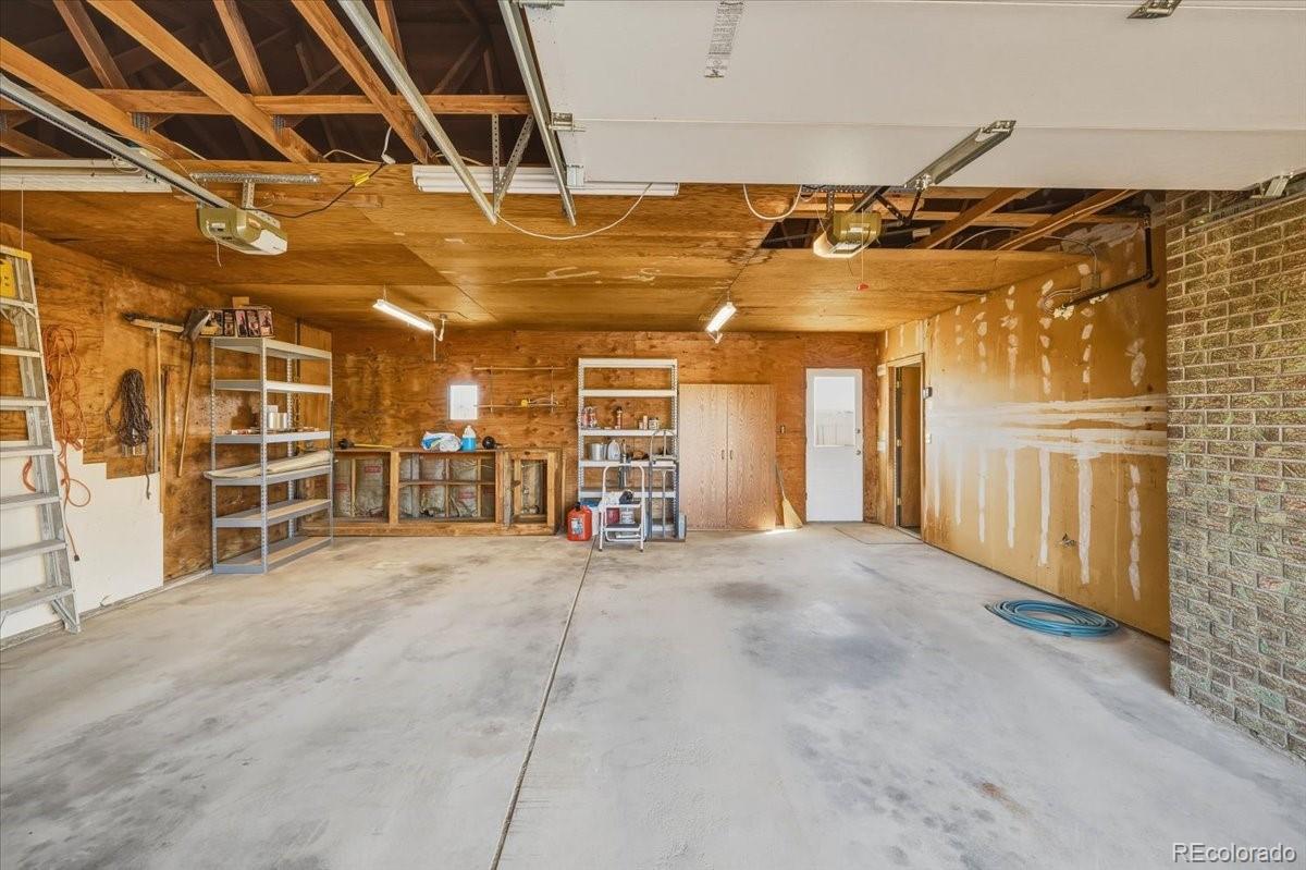 12720 South Mesa View Road Larkspur, CO 80118 - Photo 35 of 45 a view of an empty room with wooden walls