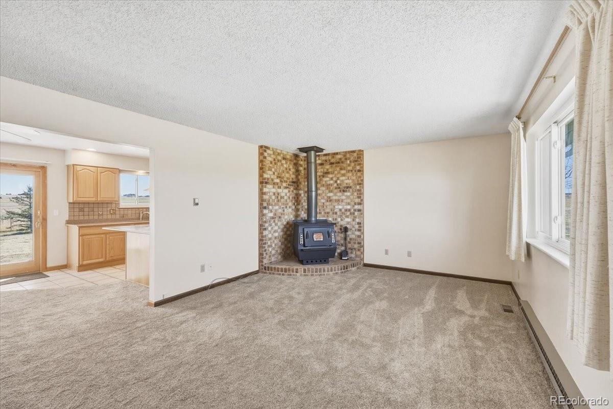 12720 South Mesa View Road Larkspur, CO 80118 - Photo 8 of 45 an empty room with windows