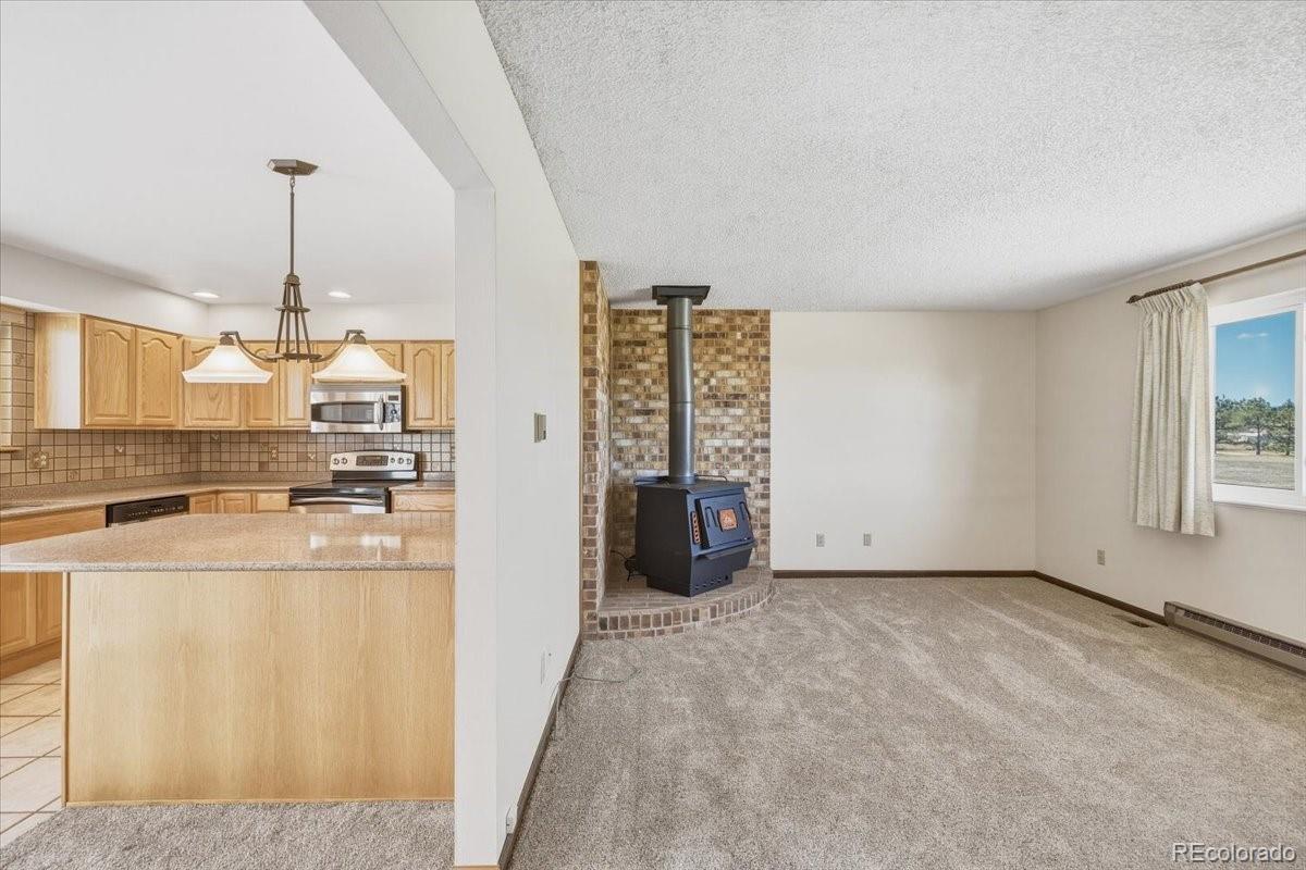 12720 South Mesa View Road Larkspur, CO 80118 - Photo 9 of 45 a view of a kitchen with refrigerator and window