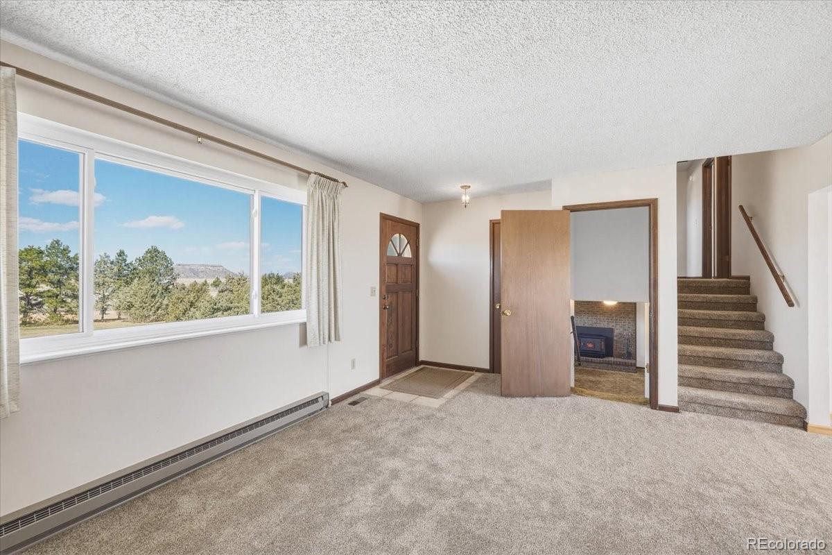 12720 South Mesa View Road Larkspur, CO 80118 - Photo 10 of 45 a view of an empty room with a window