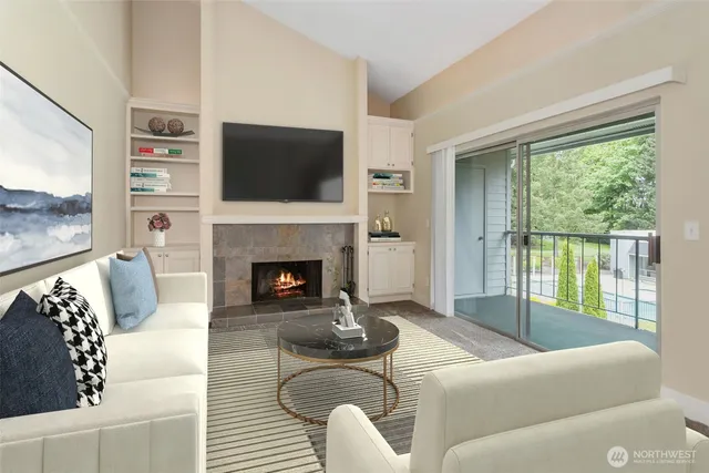 a living room with furniture a flat screen tv and a fireplace