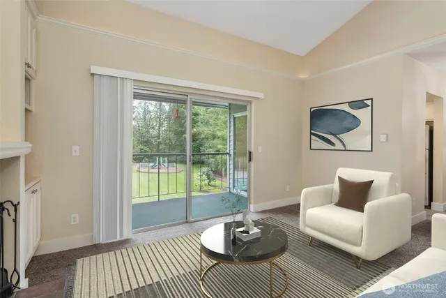a living room with furniture and a floor to ceiling window