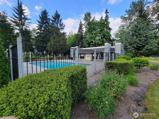 an aerial view of a house with garden space and street view