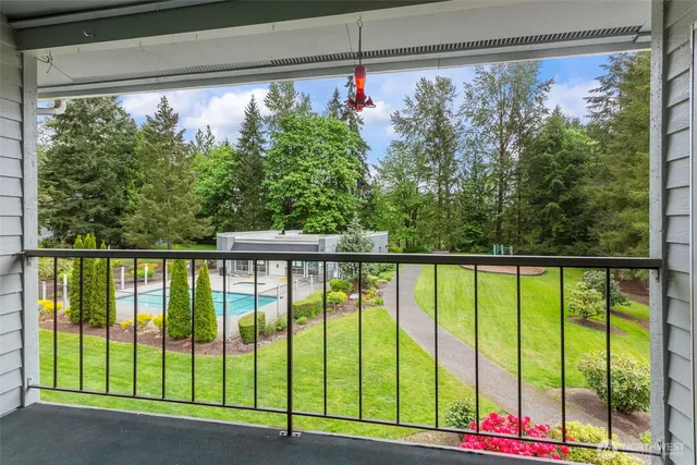 a backyard of a house with entertaining space and basket ball court