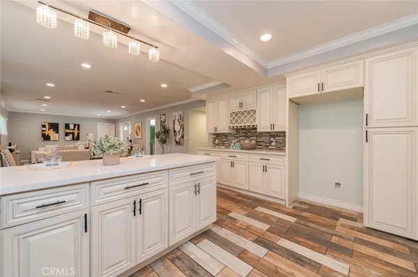 a kitchen with white cabinets and white appliances