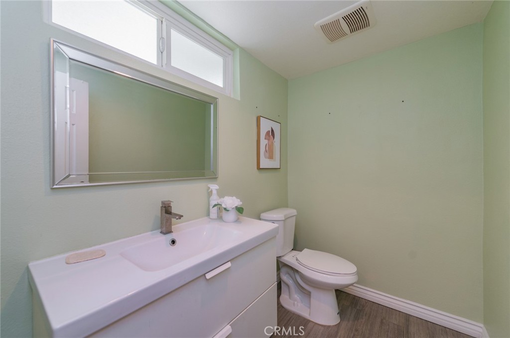 9163 Duarte Road San Gabriel, CA 91775 - Photo 16 of 38 a bathroom with a sink a toilet and a mirror