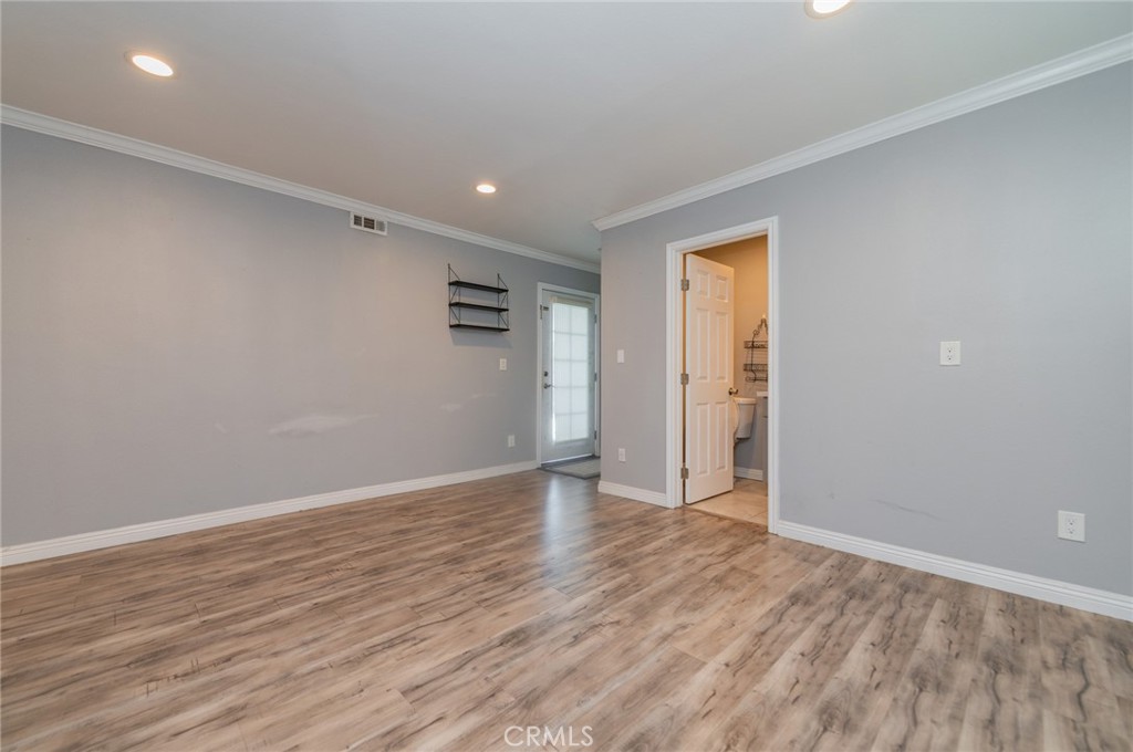 9163 Duarte Road San Gabriel, CA 91775 - Photo 18 of 38 a view of an empty room with wooden floor and a window
