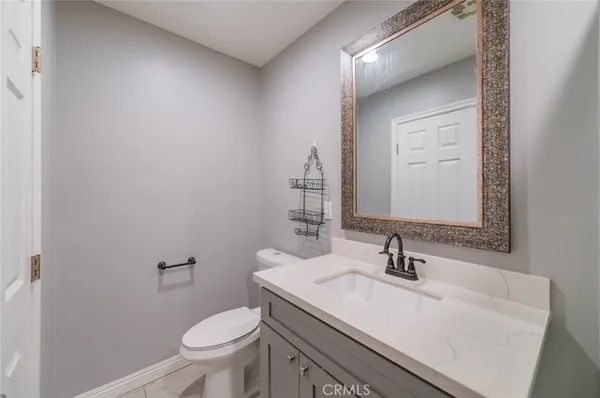 a bathroom with a sink toilet and mirror