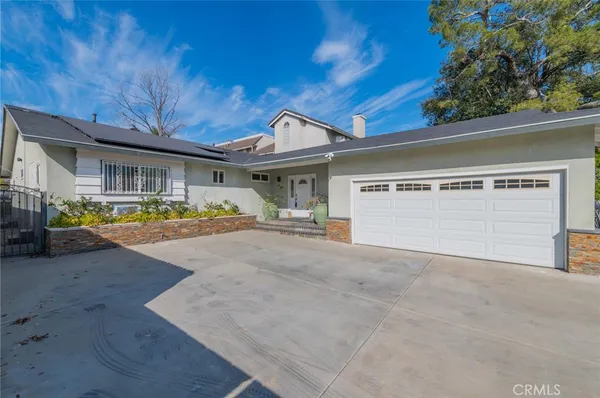 a view of large house with a yard and garage