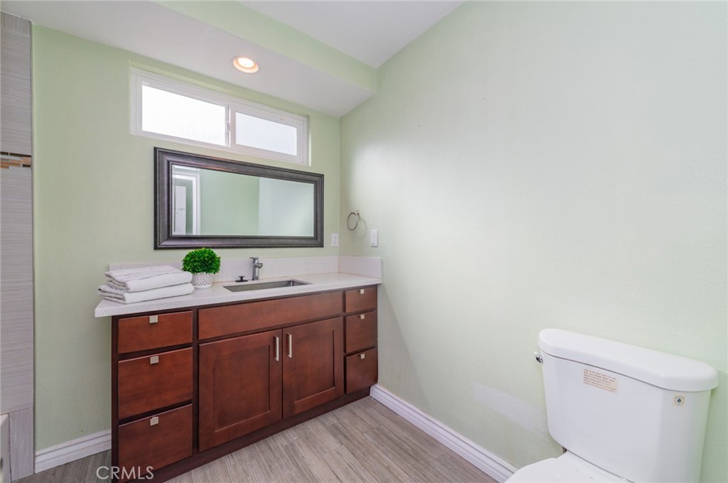 9163 Duarte Road San Gabriel, CA 91775 - Photo 27 of 38 a bathroom with a toilet sink and mirror