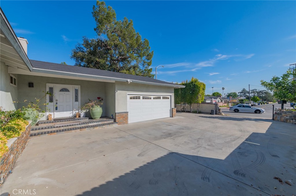 9163 Duarte Road San Gabriel, CA 91775 - Photo 3 of 38 a view of a house with potted plants and a large tree