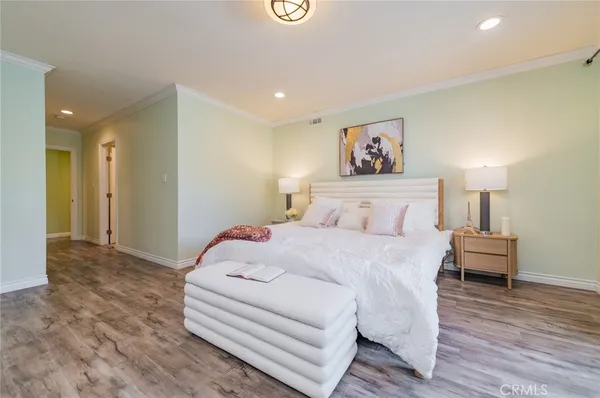 a spacious bedroom with a bed and a couch