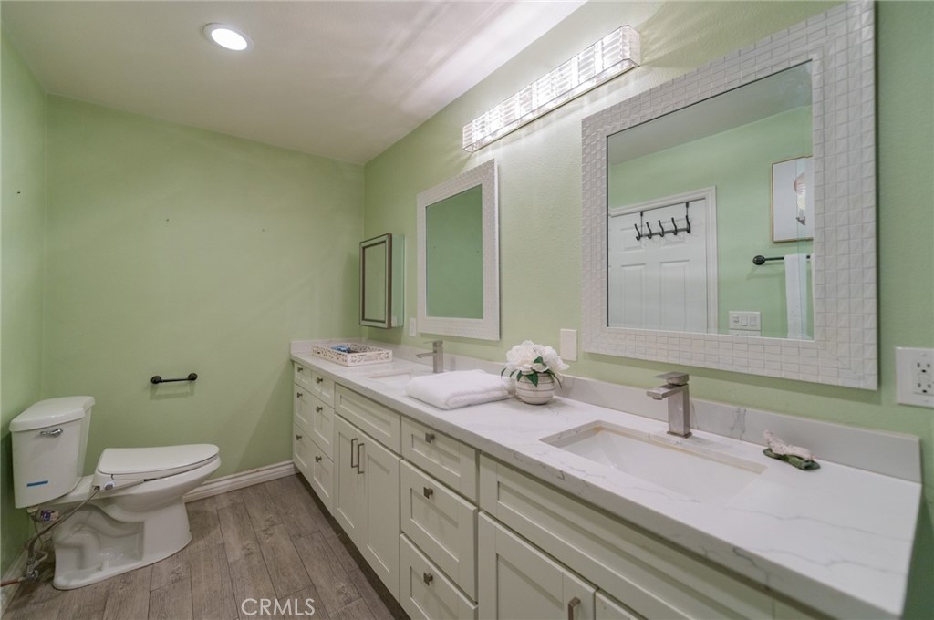 9163 Duarte Road San Gabriel, CA 91775 - Photo 33 of 38 a bathroom with a double vanity sink toilet and mirror