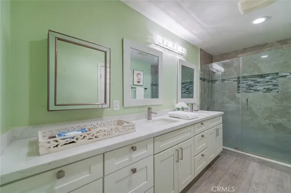 a bathroom with a sink double vanity granite and a mirror