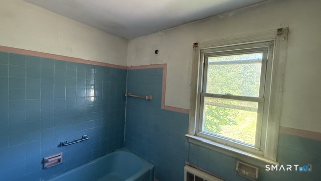131 Bryden Terrace Hamden, CT 06517 - Photo 13 of 16 a bathroom with a bathtub and a window