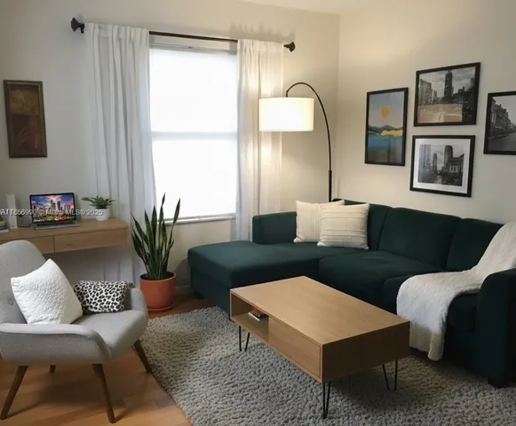 a living room with furniture and a large window