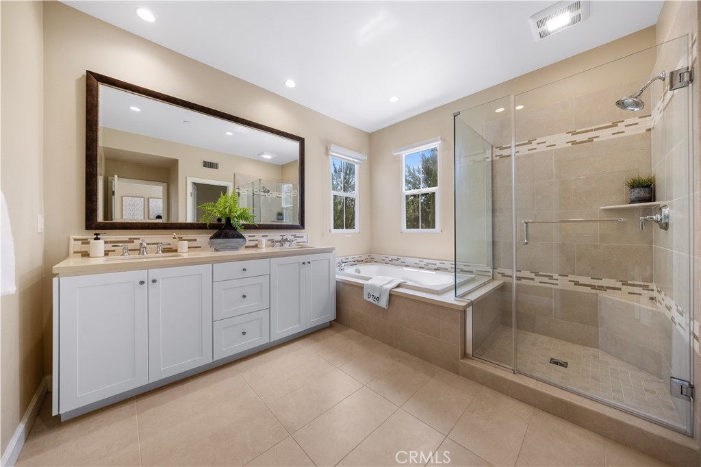 114 Omar Irvine, CA 92620 - Photo 14 of 25 a spacious bathroom with a granite countertop sink mirror and shower