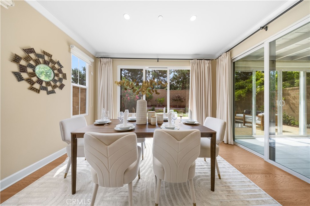 114 Omar Irvine, CA 92620 - Photo 6 of 25 a dining room with furniture a rug and wooden floor
