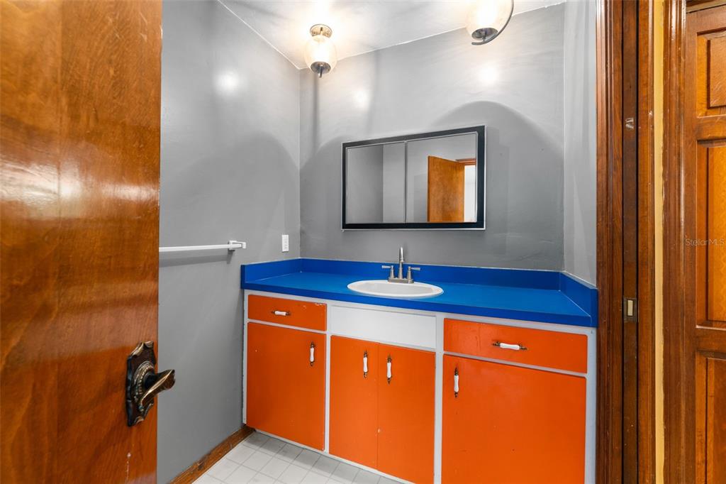 4703 Northwest 124th Street Gainesville, FL 32606 - Photo 40 of 55 a bathroom with a sink a light fixture and a mirror