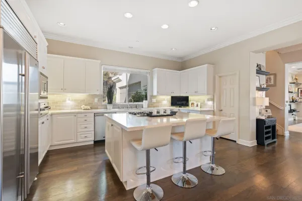 a kitchen with a sink cabinets and refrigerator
