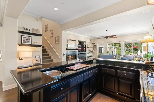 a kitchen with granite countertop a sink and a stove