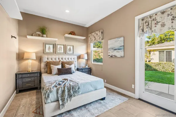 a bedroom with a bed and a night stand