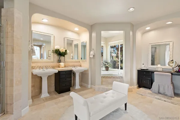 a bathroom with a tub sink and mirror