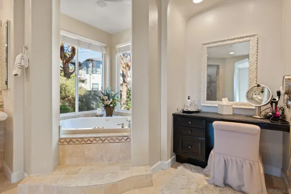 a white bath tub sitting in front of a window