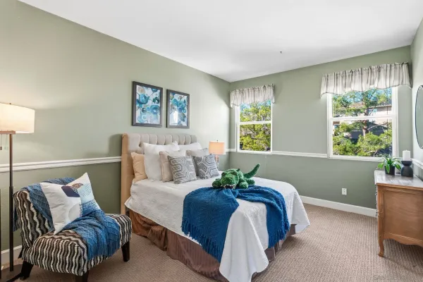 a bedroom with a bed and a window