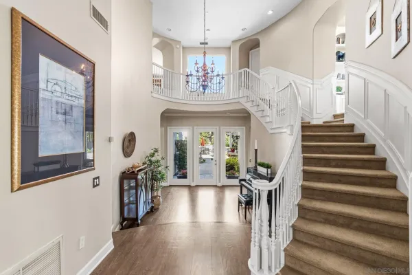 a view of an entryway with wooden floor and a chandelier