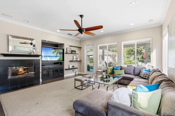 a living room with furniture a fireplace and a flat screen tv