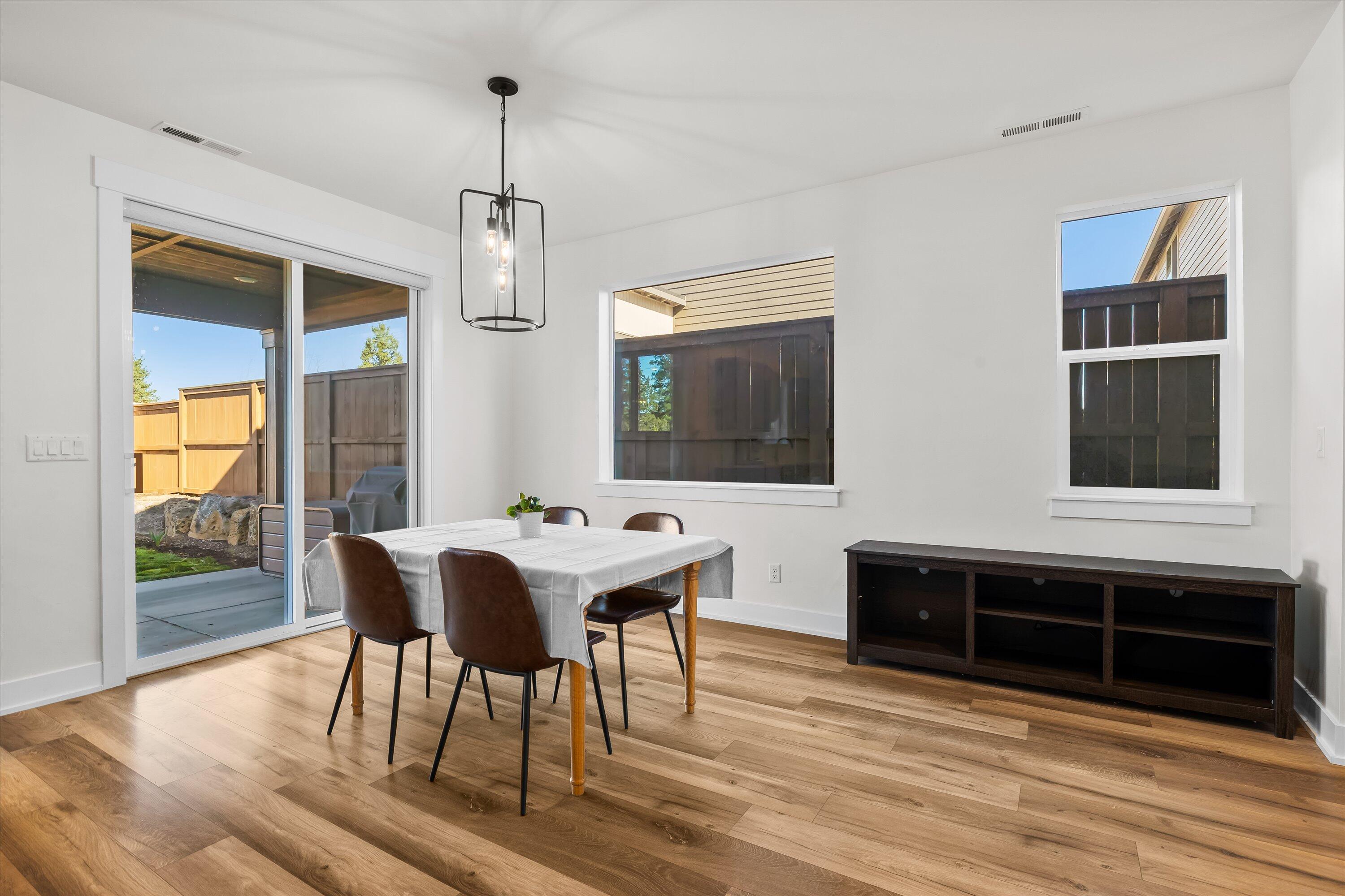 60903 Southeast Epic Place Bend, OR 97702 - Photo 17 of 48 a view of a dining room with furniture window and wooden floor