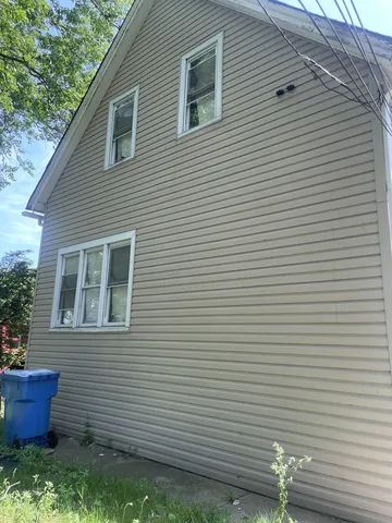 a view of house that has a yard