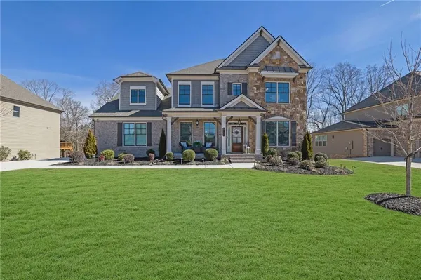 a front view of a house with swimming pool having outdoor seating