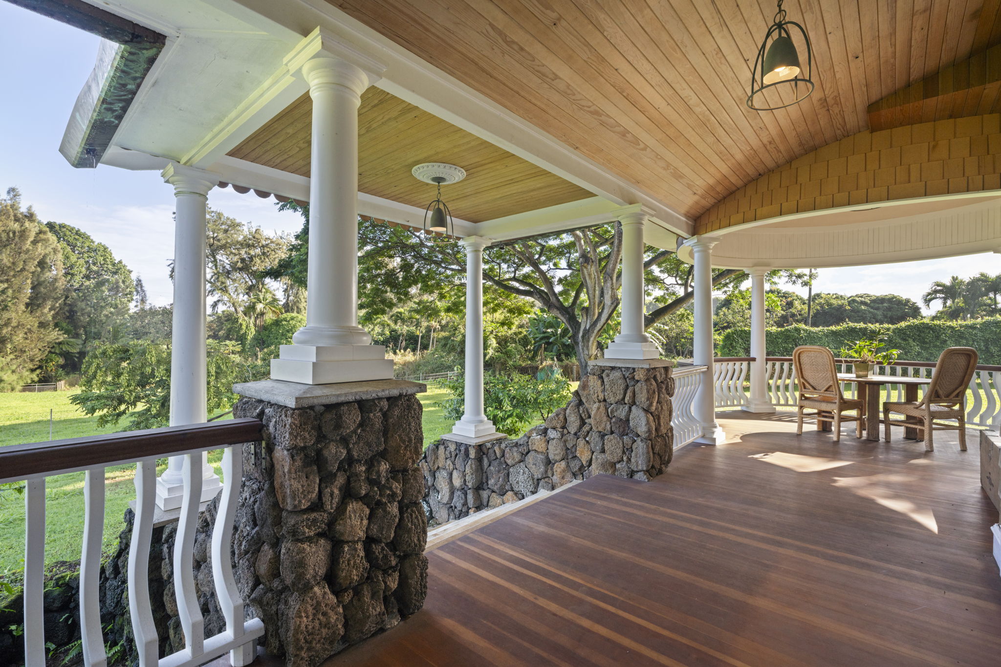 4691 Wailapa Road Kilauea, HI 96754 - Photo 18 of 30 a view of a patio with table and chairs potted plants with wooden floor and floor to ceiling window