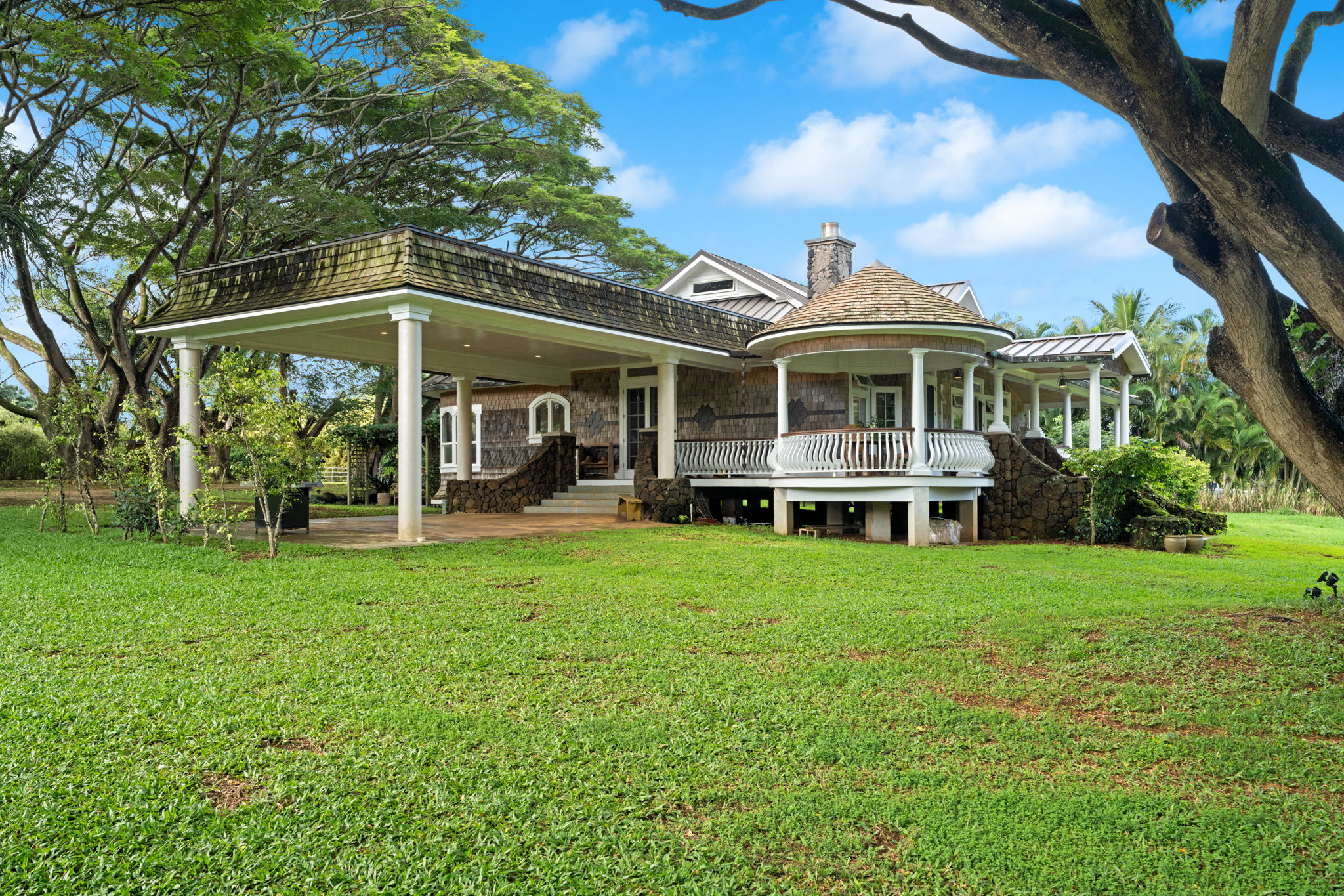 4691 Wailapa Road Kilauea, HI 96754 - Photo 24 of 30 a front view of a house with a yard table and chairs