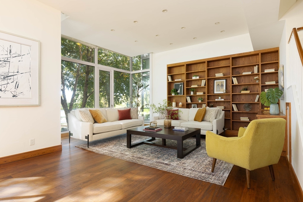 975 Memorial Drive, Unit 209 Cambridge, MA 02138 - Photo 2 of 23 a living room with furniture large window and wooden floor