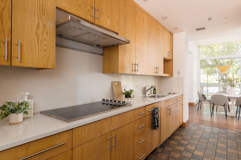 975 Memorial Drive, Unit 209 Cambridge, MA 02138 - Photo 9 of 23 a kitchen with sink cabinets and window