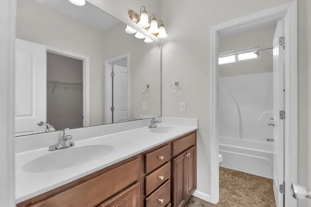 a bathroom with a sink double vanity and a mirror