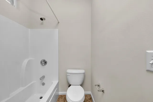 a bathroom with a toilet and a bathtub