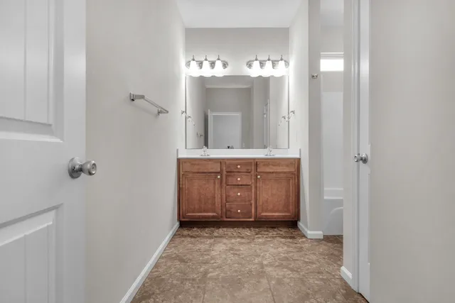 a view of a backyard with plants and wooden fence