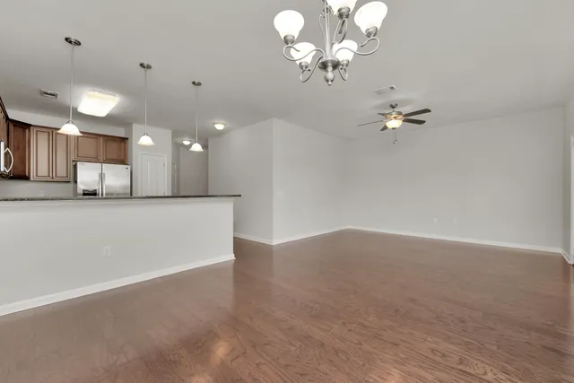 a view of a chandelier fan and kitchen view