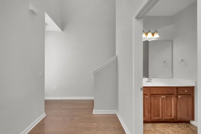 a view of a hallway with wooden cabinets