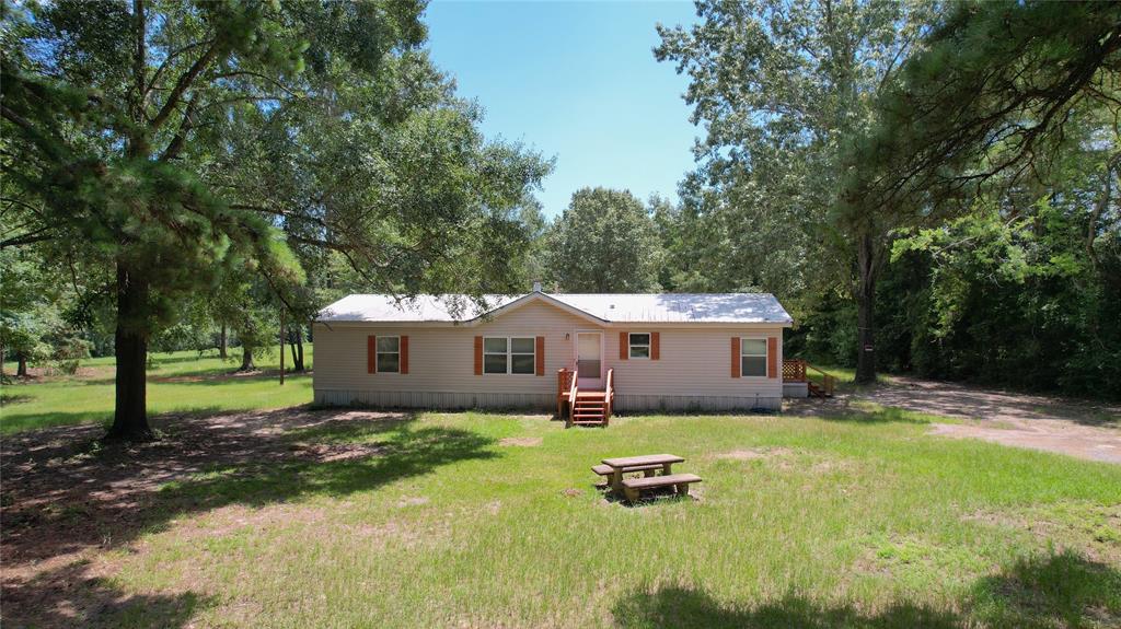 191 Circle Drive Mansfield, LA 71052 - Photo 2 of 22 a front view of a house with a yard and trees